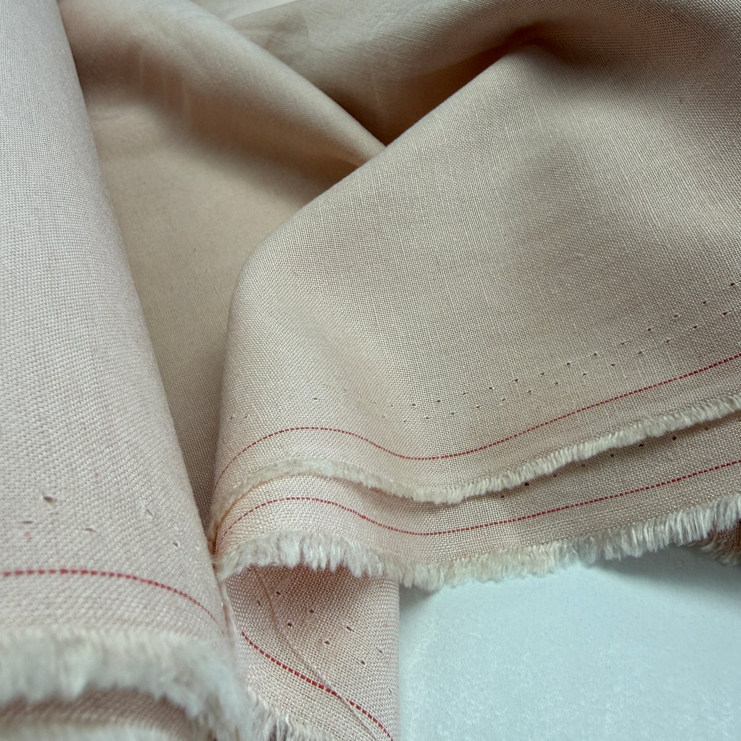 Linen + Viscose + Cotton Mix fabric in light coral pink, showcasing a beautiful drape and texture ideal for summer apparel and home decor.